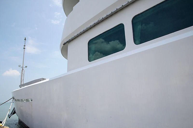 a white boat with a tower in the background aboard ASEAN LADY Yacht for Sale