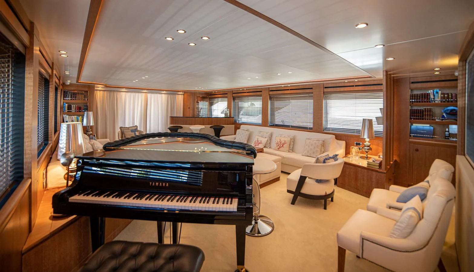 a large room with a piano and a couch aboard B TWO Yacht for Sale