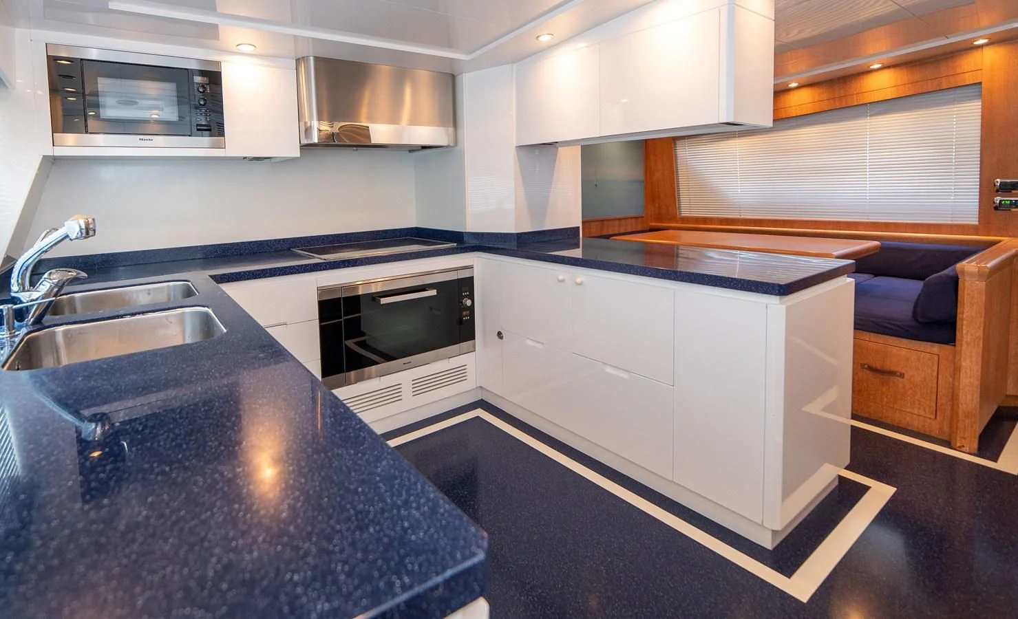a kitchen with white cabinets aboard B TWO Yacht for Sale