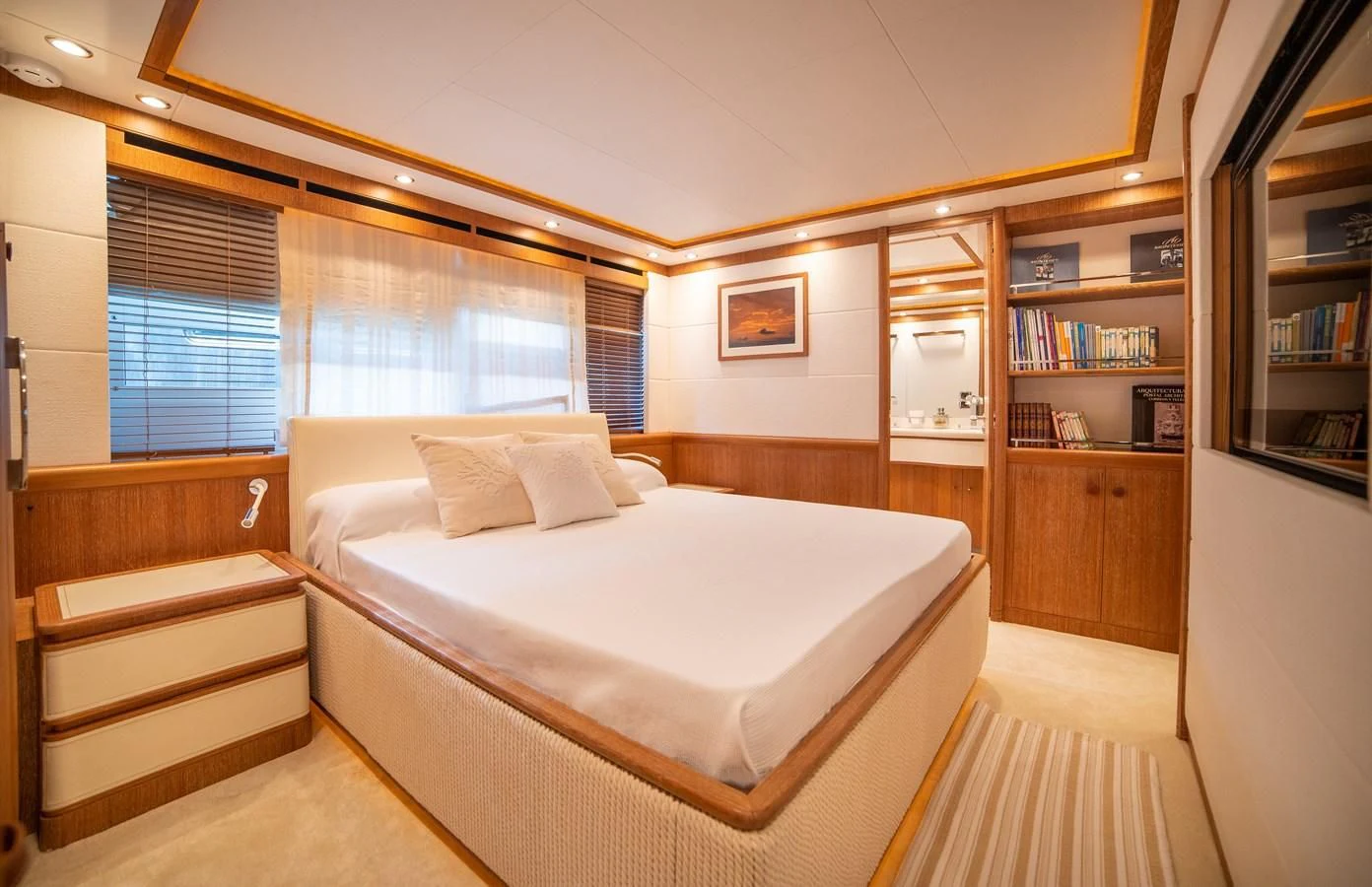 a bedroom with a bed and a bookcase aboard B TWO Yacht for Sale