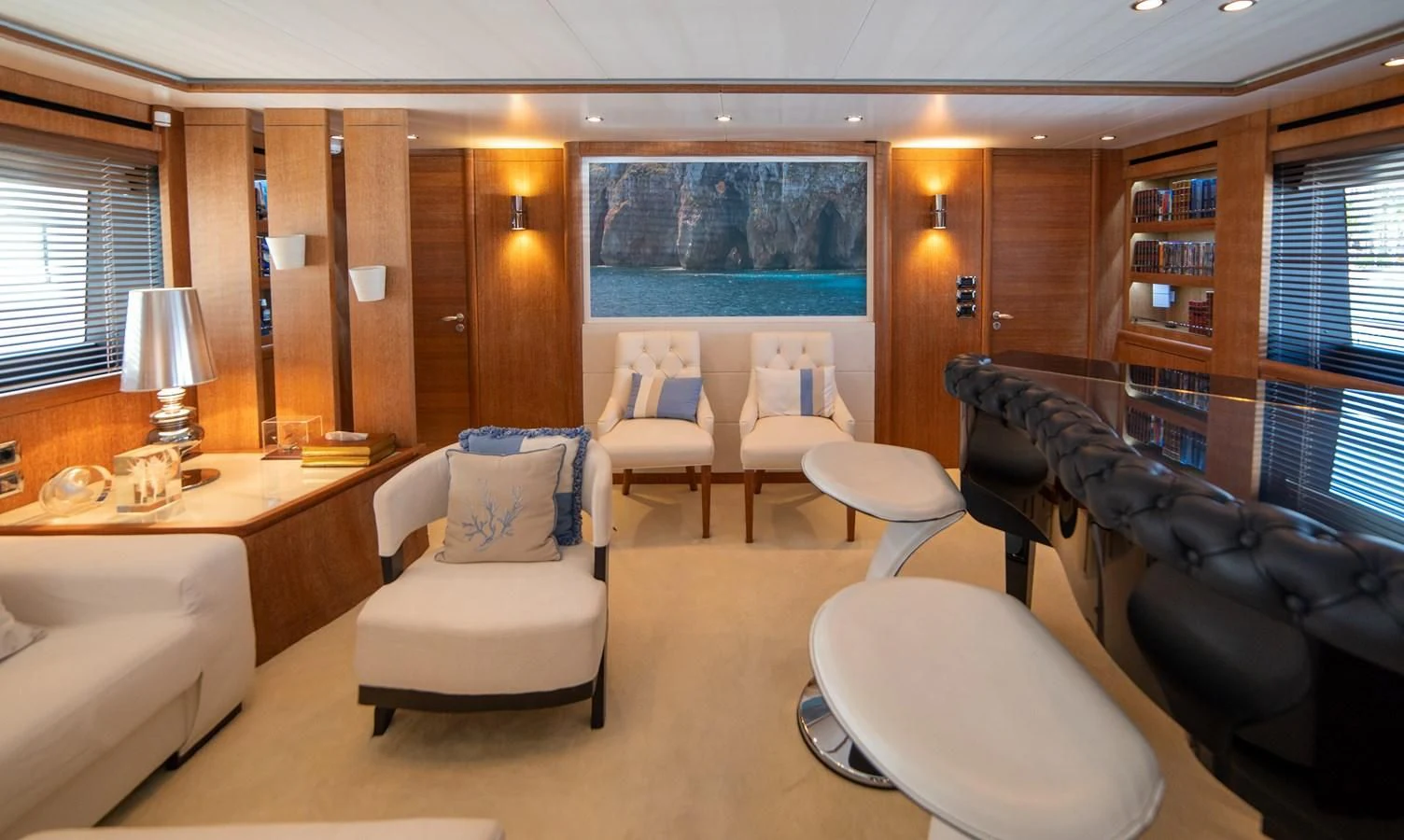 a living room with a large book shelf and a couch aboard B TWO Yacht for Sale
