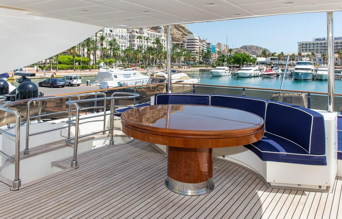 a table on a deck overlooking a marina aboard B TWO Yacht for Sale