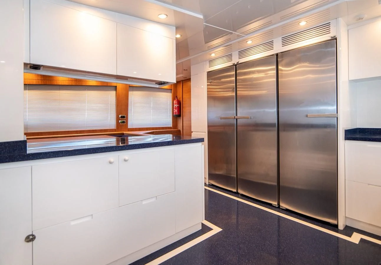 a large kitchen with a stainless steel refrigerator aboard B TWO Yacht for Sale