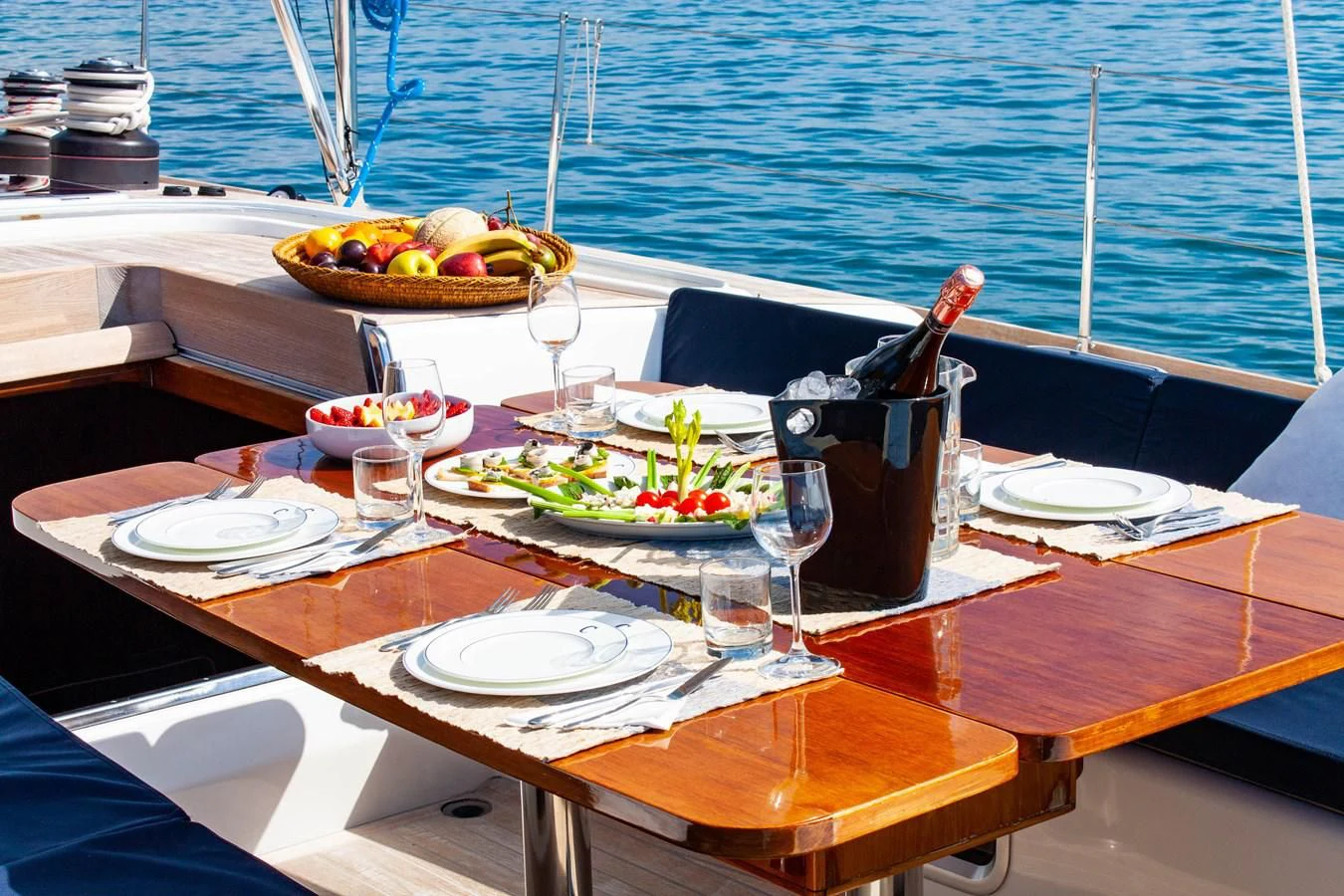a table with food and drinks on it aboard NAUTA-PETERSON 75 Yacht for Sale