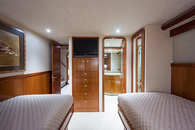 a bedroom with a bed and a television aboard SLEEPOVER Yacht for Sale