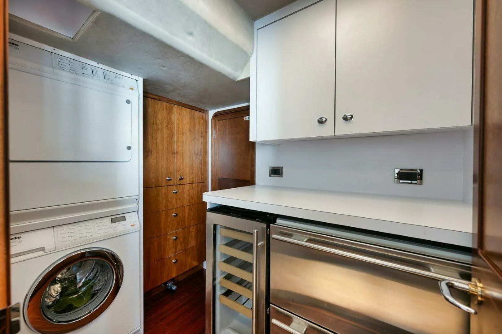 a kitchen with white cabinets aboard SLEEPOVER Yacht for Sale