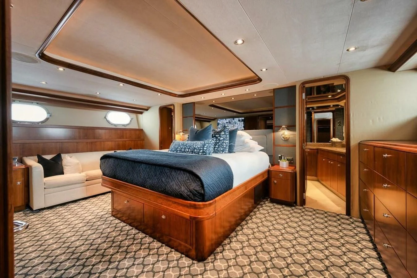 a bedroom with a bed and a couch aboard SLEEPOVER Yacht for Sale