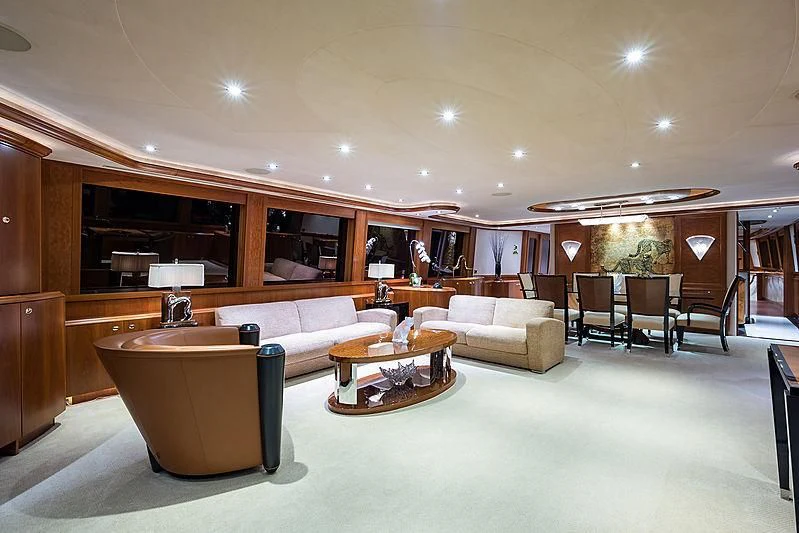 a large living room with a large table and chairs aboard SLEEPOVER Yacht for Sale
