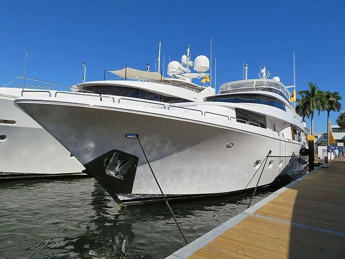 a white yacht docked at a dock aboard SLEEPOVER Yacht for Sale