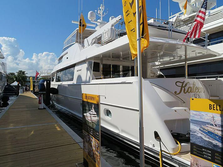 a white boat on a dock aboard SLEEPOVER Yacht for Sale
