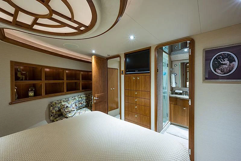 a bedroom with a bed and a television aboard SLEEPOVER Yacht for Sale