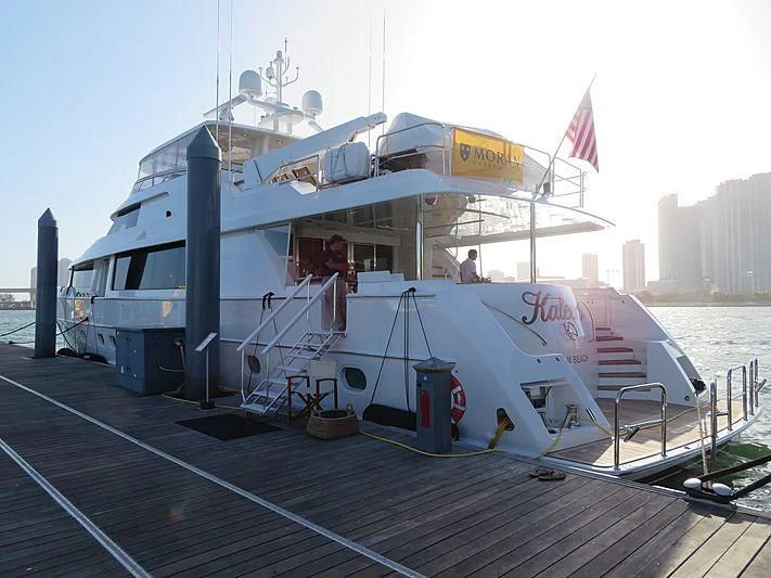 a large white boat with a flag on the deck aboard SLEEPOVER Yacht for Sale