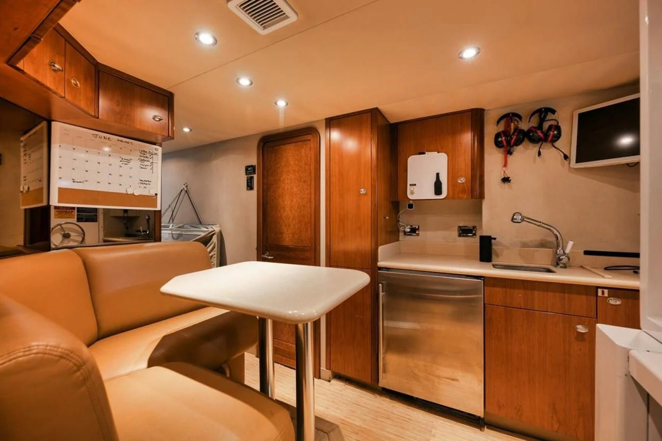 a kitchen with a sink and a couch aboard SLEEPOVER Yacht for Sale