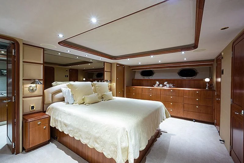 a bedroom with a bed and a closet aboard SLEEPOVER Yacht for Sale