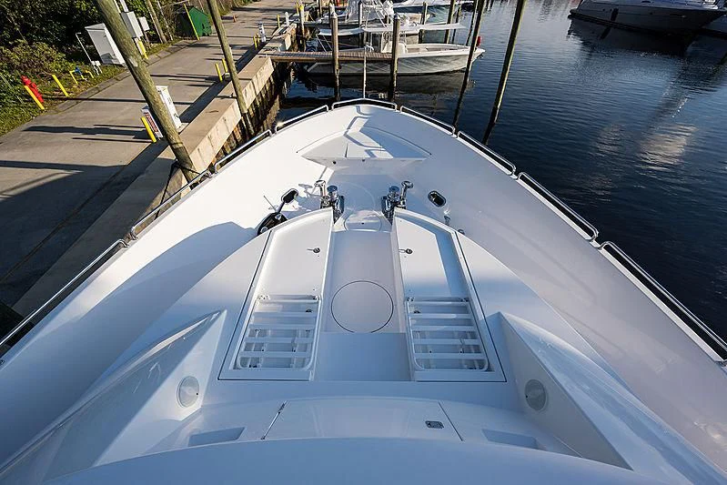a white boat on a body of water aboard SLEEPOVER Yacht for Sale