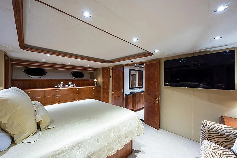 a bedroom with a bed and a television aboard SLEEPOVER Yacht for Sale