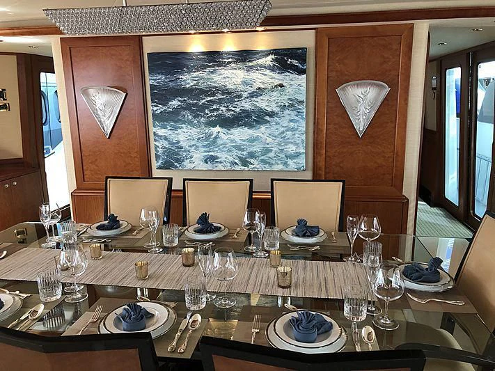 a table with plates and glasses aboard SLEEPOVER Yacht for Sale