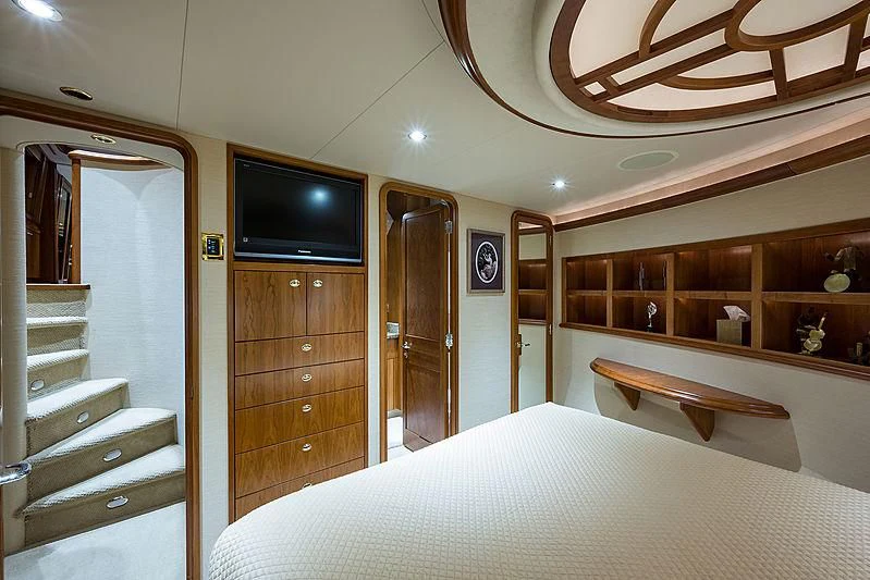 a bedroom with a tv and a bed aboard SLEEPOVER Yacht for Sale
