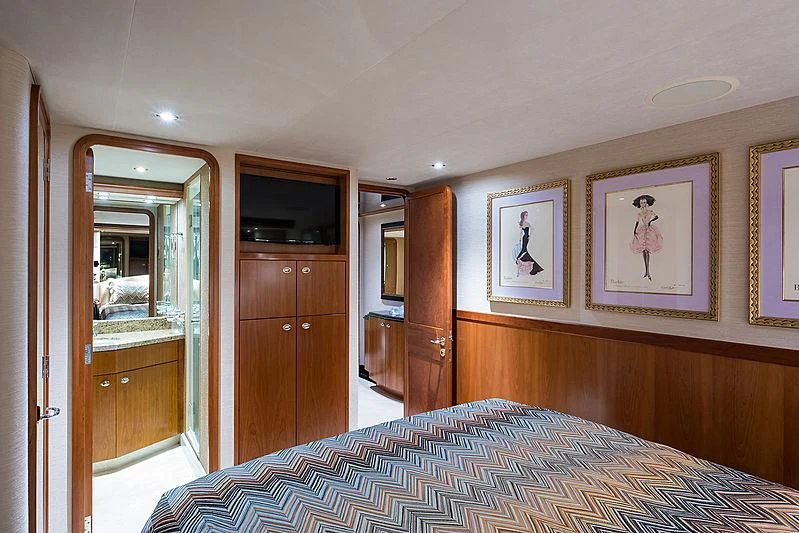 a bedroom with a bed and a television aboard SLEEPOVER Yacht for Sale