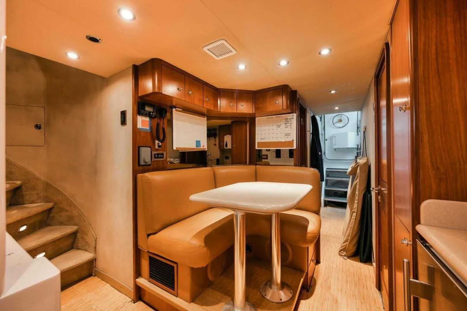 a kitchen with a table and chairs aboard SLEEPOVER Yacht for Sale