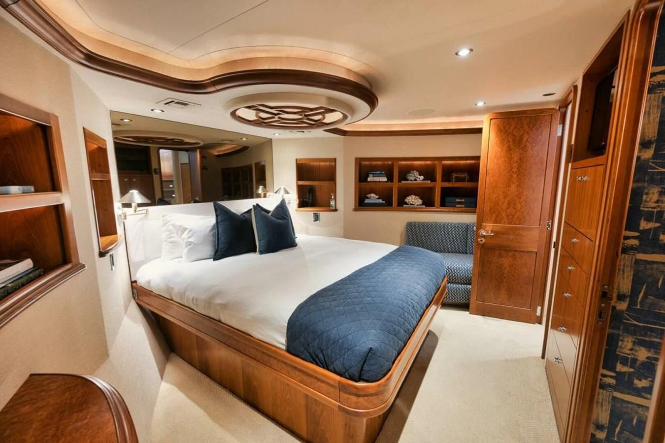 a bedroom with a bed and a chair aboard SLEEPOVER Yacht for Sale