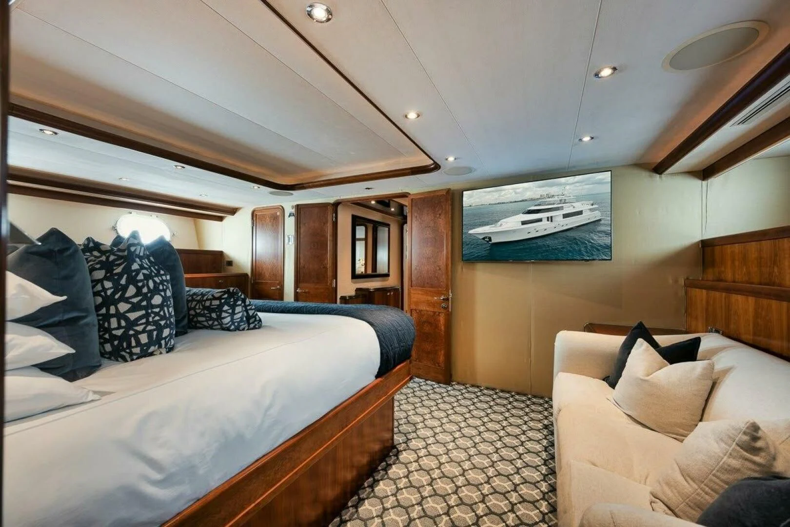 a bedroom with a bed and a couch aboard SLEEPOVER Yacht for Sale