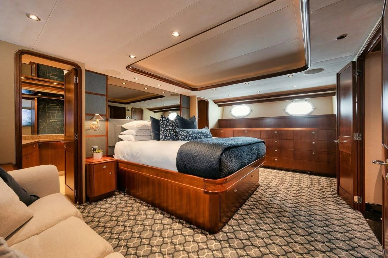 a bedroom with a bed and a couch aboard SLEEPOVER Yacht for Sale
