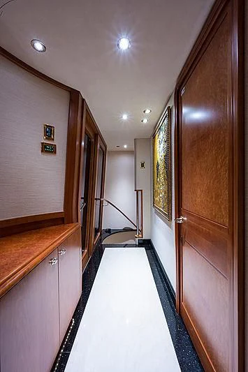 a long hallway with a door and a railing aboard SLEEPOVER Yacht for Sale