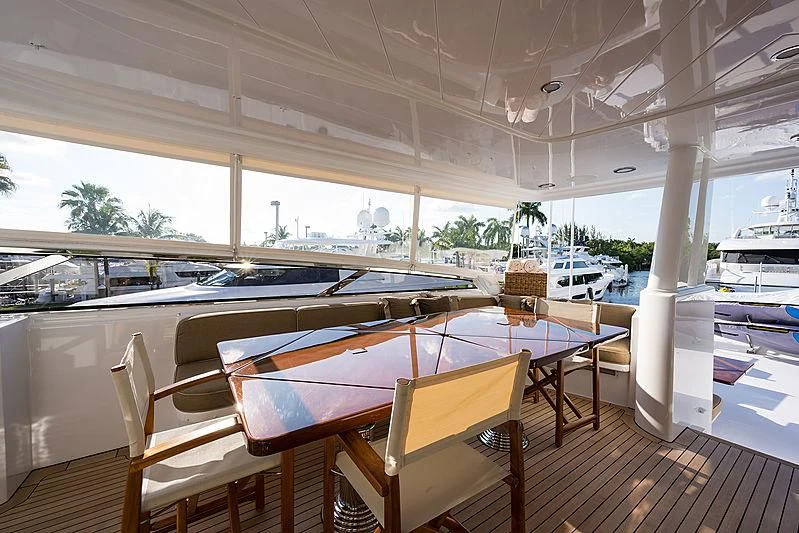a table and chairs on a deck aboard SLEEPOVER Yacht for Sale