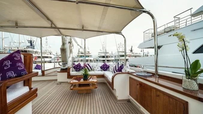 a room with a table and chairs aboard TAMARITA Yacht for Sale
