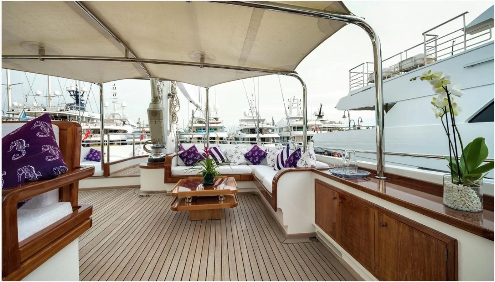 a room with a table and chairs aboard TAMARITA Yacht for Sale