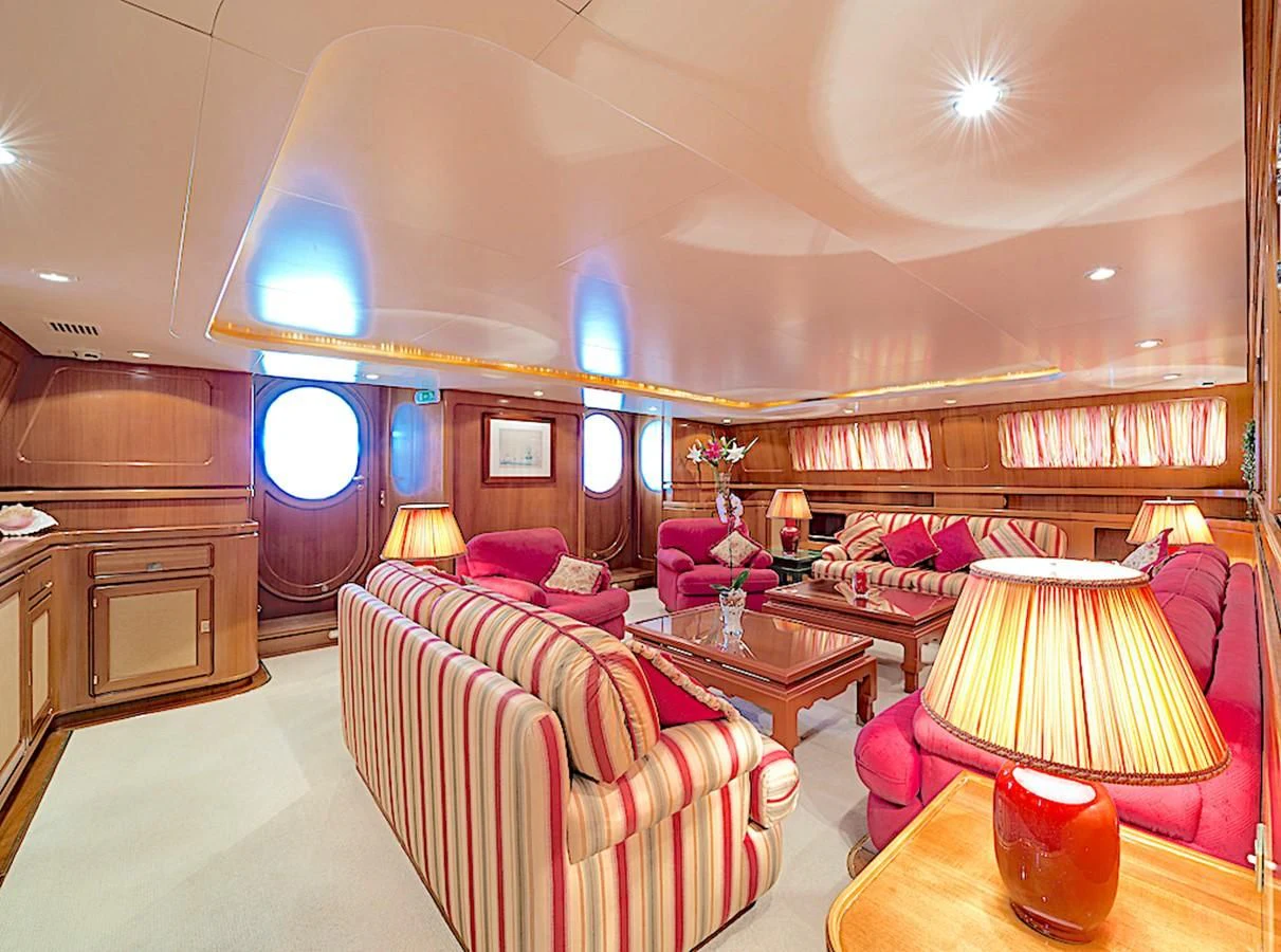 a room with a bed and a table aboard TAMARITA Yacht for Sale