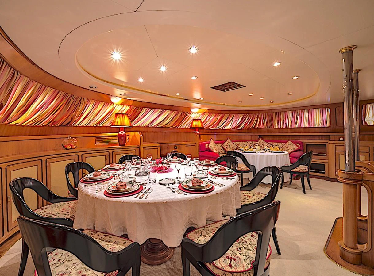 a dining room with a table set aboard TAMARITA Yacht for Sale