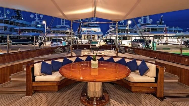 a table and chairs in a room aboard TAMARITA Yacht for Sale