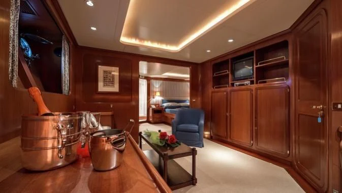 a kitchen with wooden cabinets aboard TAMARITA Yacht for Sale