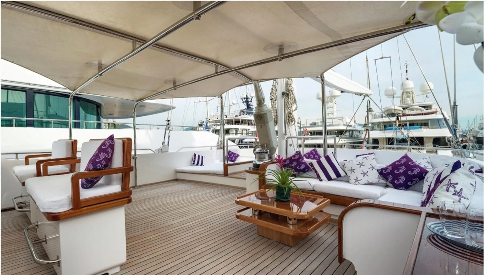 a boat with pillows and a table aboard TAMARITA Yacht for Sale