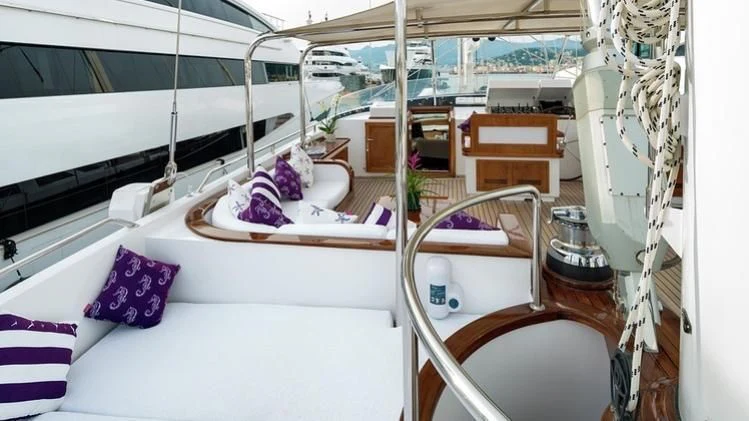 a room with a bed and a chair aboard TAMARITA Yacht for Sale