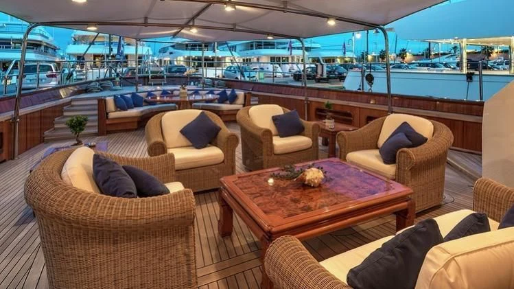 a large living room with a large swimming pool aboard TAMARITA Yacht for Sale