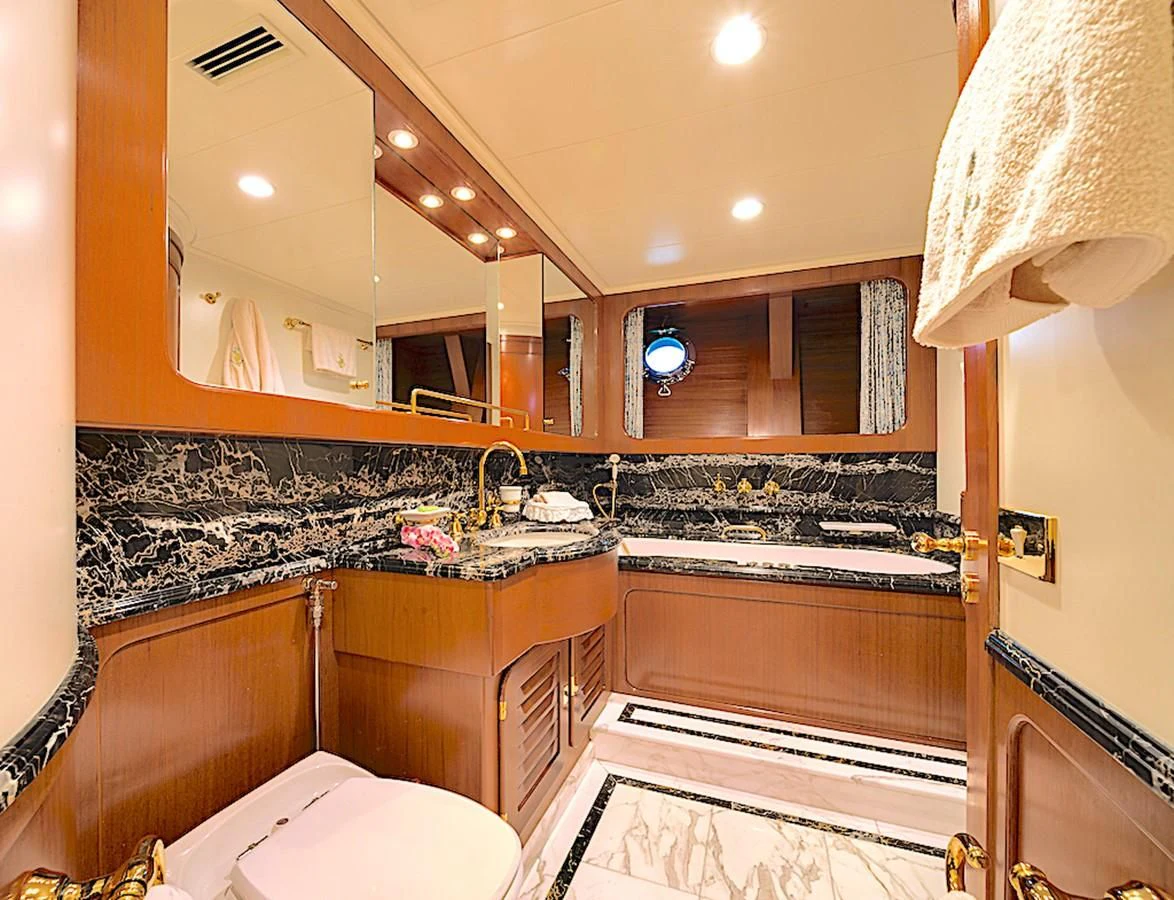 a bathroom with a large mirror aboard TAMARITA Yacht for Sale