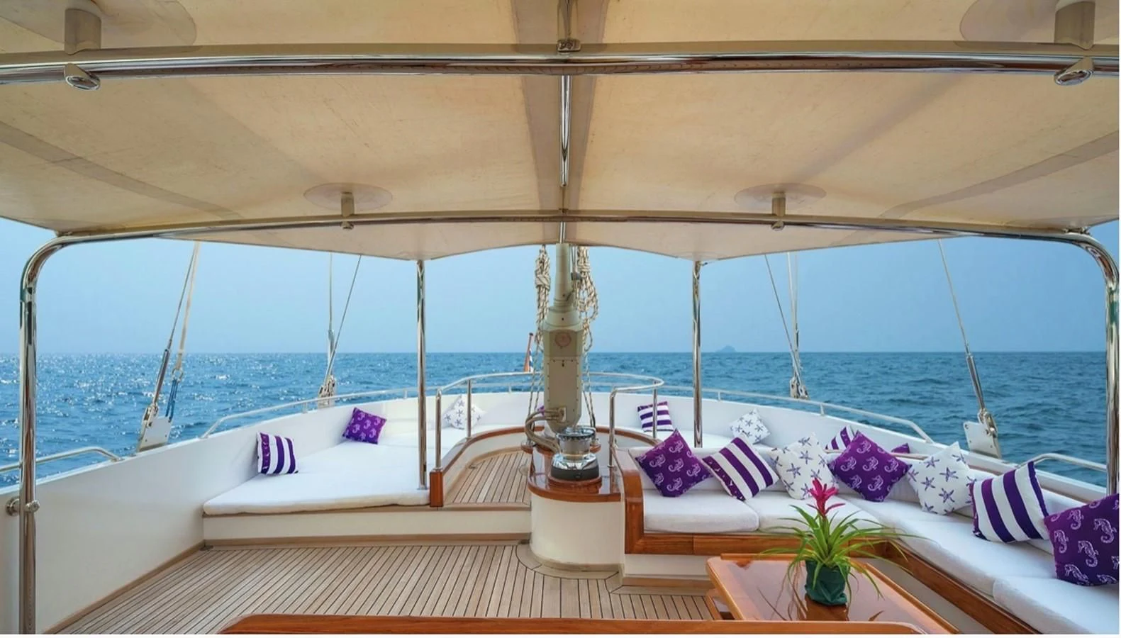 a room with a large bed and a large window overlooking the ocean aboard TAMARITA Yacht for Sale
