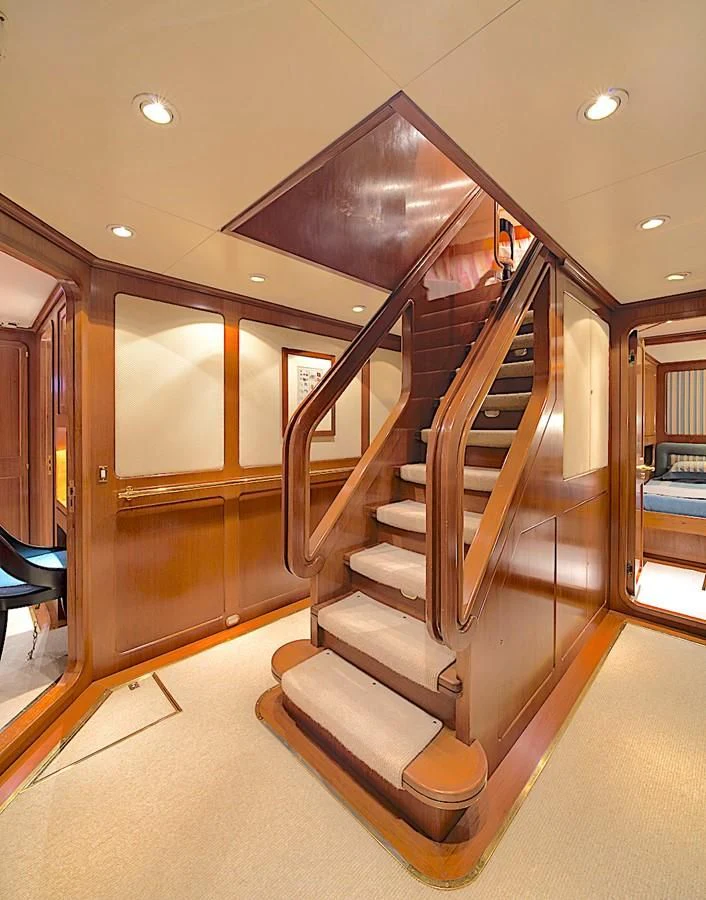 a wood staircase in a building aboard TAMARITA Yacht for Sale