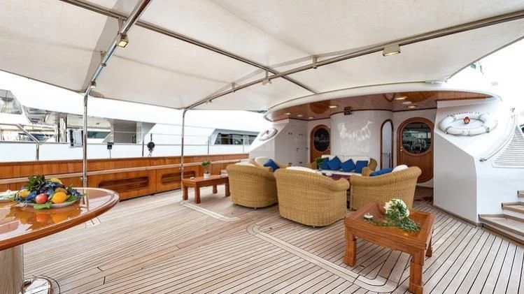 a room with a table and chairs aboard TAMARITA Yacht for Sale