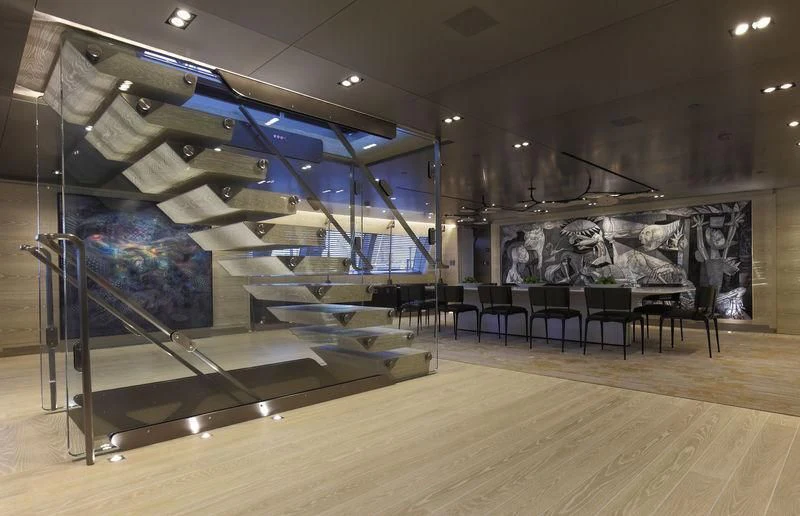 a large room with chairs and a large painting on the wall aboard BADIS I Yacht for Sale