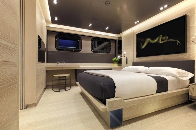 a room with a bed and tv aboard BADIS I Yacht for Sale
