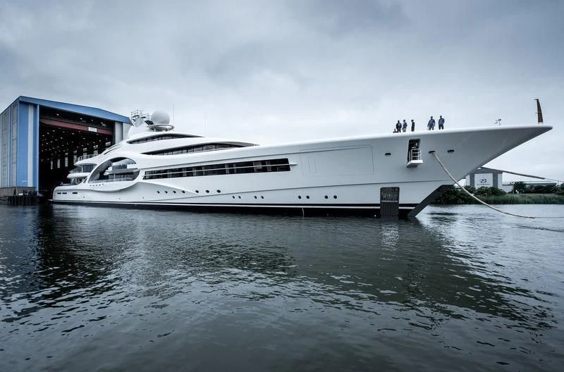 a white yacht docked at a pier aboard AMBASSADOR Yacht for Sale