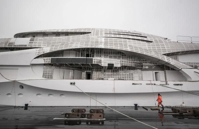 a person walking next to a large building aboard AMBASSADOR Yacht for Sale