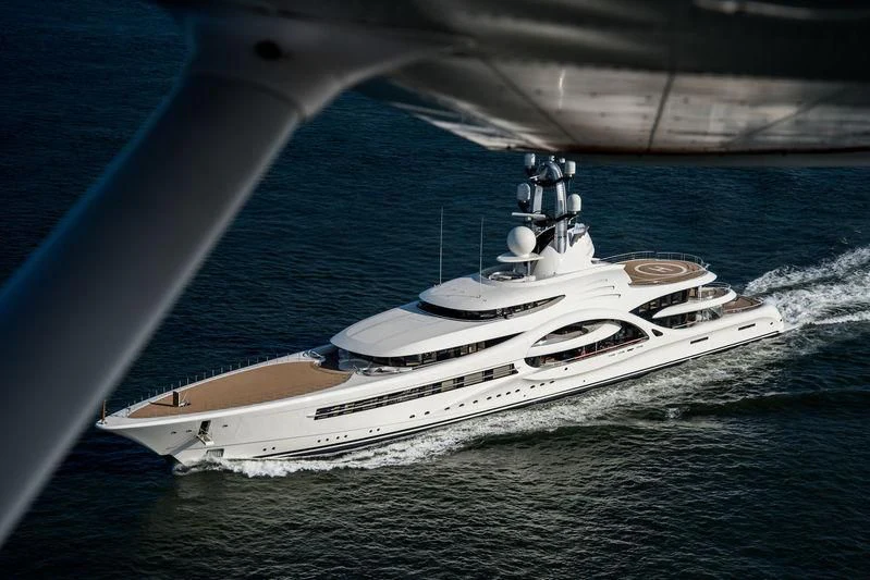 a ship under the wing of a plane aboard AMBASSADOR Yacht for Sale