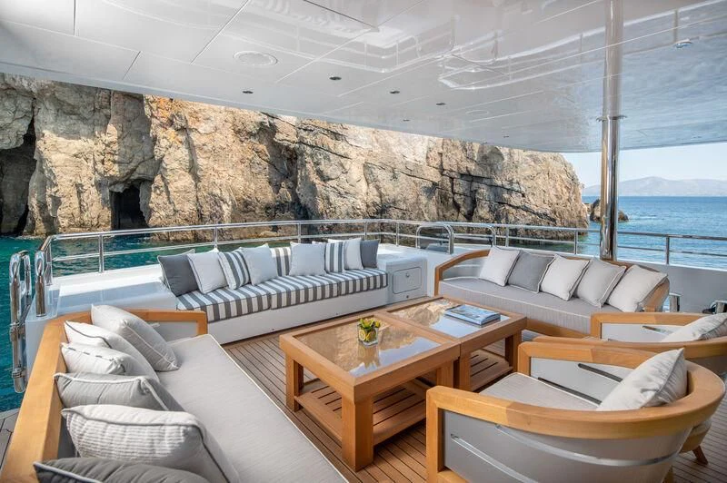 a living room with a large stone wall aboard BOJI Yacht for Sale