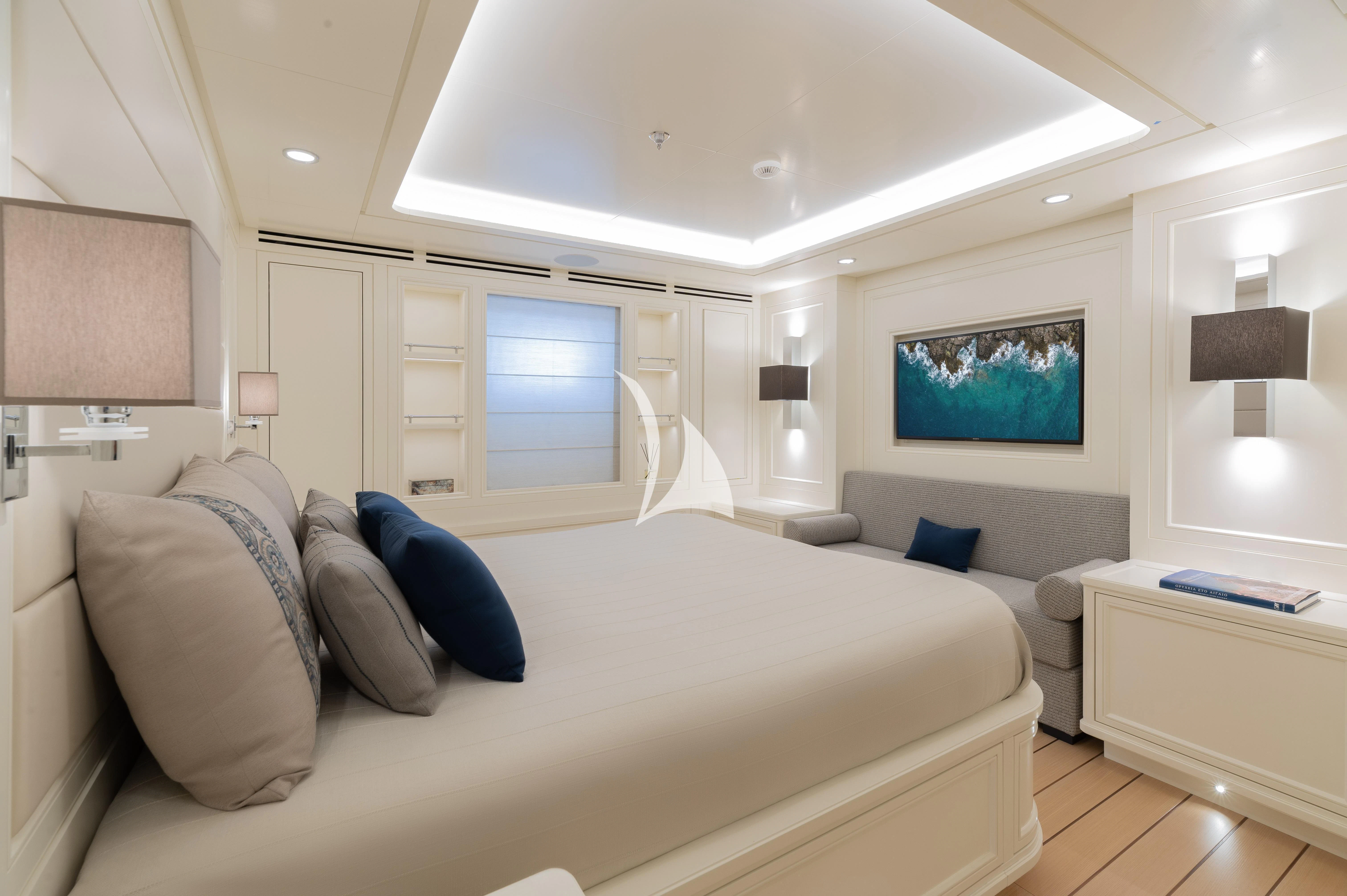 a large white bedroom with a large bed and a flat screen television aboard BOJI Yacht for Sale