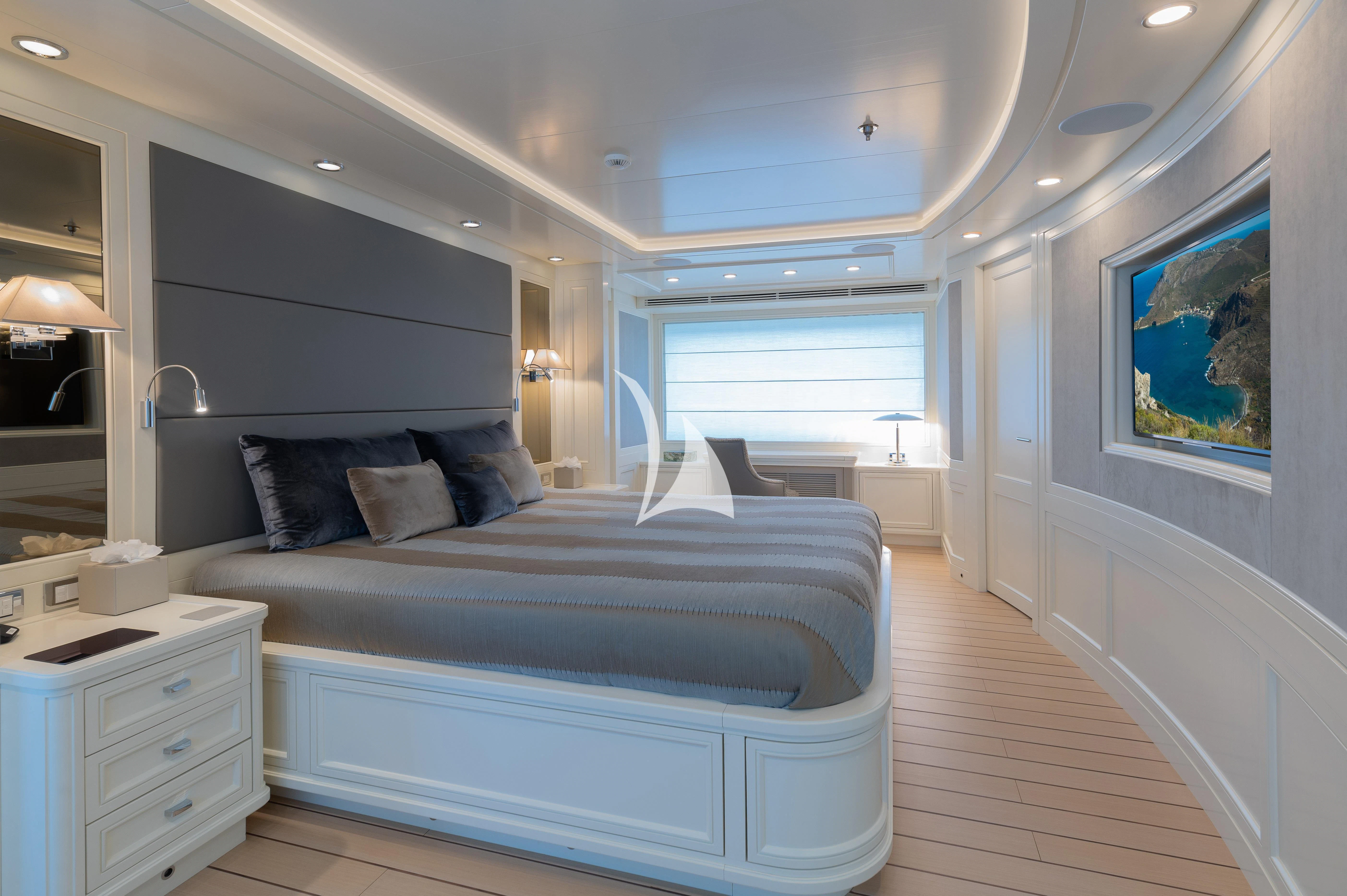 a bedroom with a bed and a window aboard BOJI Yacht for Sale